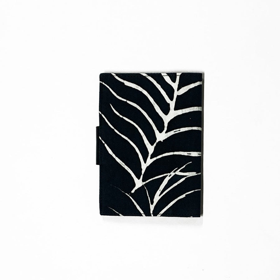 A whitebox photo of passport cover in black fern pattern showing outside and back side of the passport cover