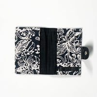 the inside view of a passport cover made of batik in the pattern black bunga