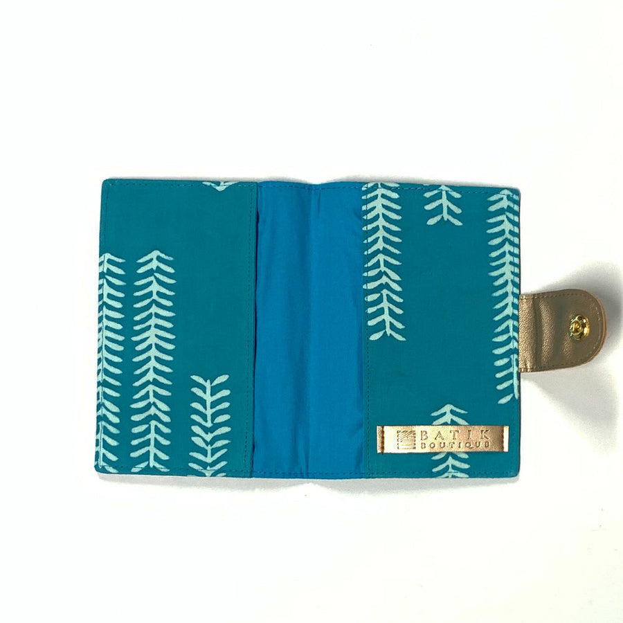 a photo of a passport cover made of batik showcasing the inside in the pattern mint arrow