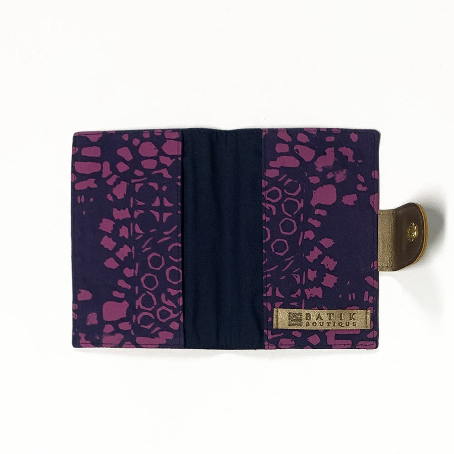 an open view of a passport cover made of batik in the pattern purple bintik