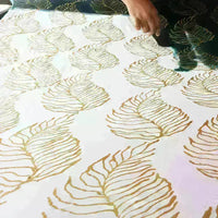 An artisan is coloring batik fabric