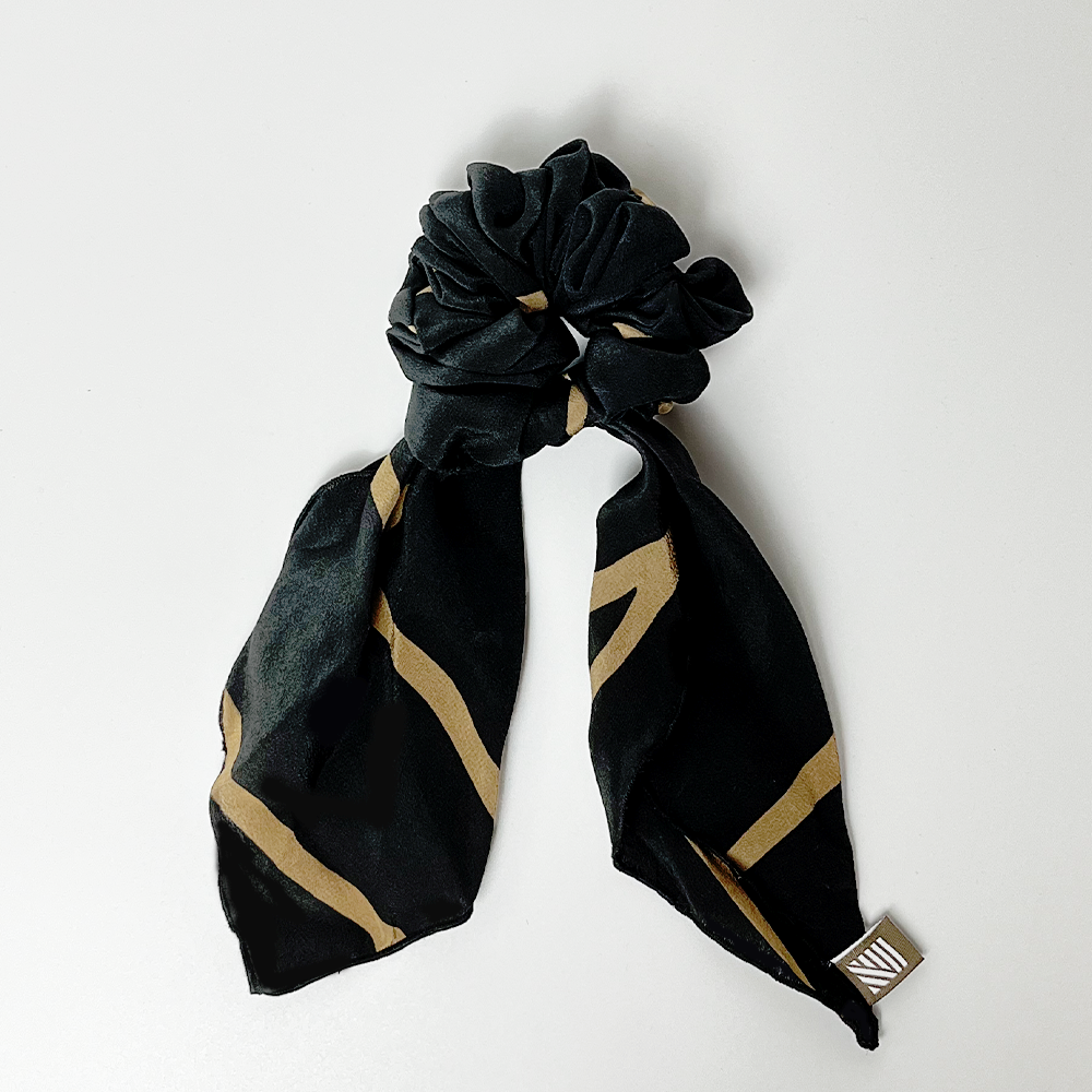 a whitebox photo of batik scrunchies in the pattern black ecru