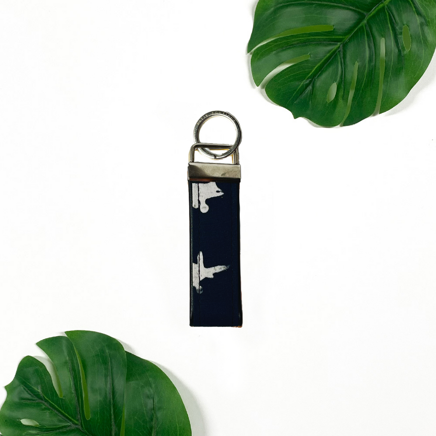 a lifestyle photo of authentic batik key fob in the pattern black airplane