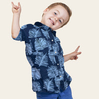 A youthful model strikes a pose while wearing a Navy Sawit patterned batik shirt, set against a neutral background