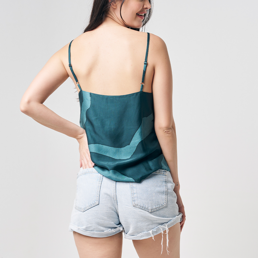 A rear view shot capturing a model posing against a neutral background, with her hand casually in her back pocket, showcasing the enchanting Forest Chain pattern