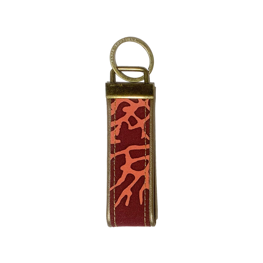 a photo of a keyfob made of batik in the pattern maroon coral 
