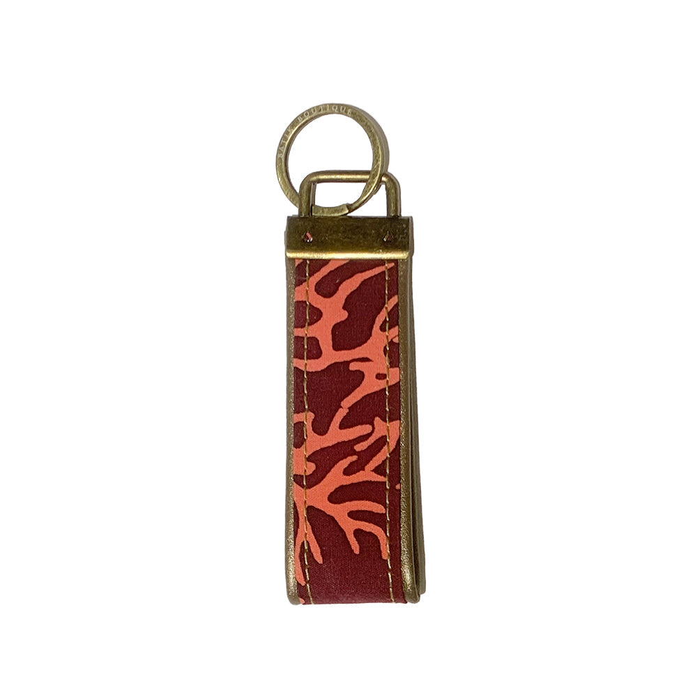 a photo of the back side of a keyfob made of batik in the pattern maroon coral 
