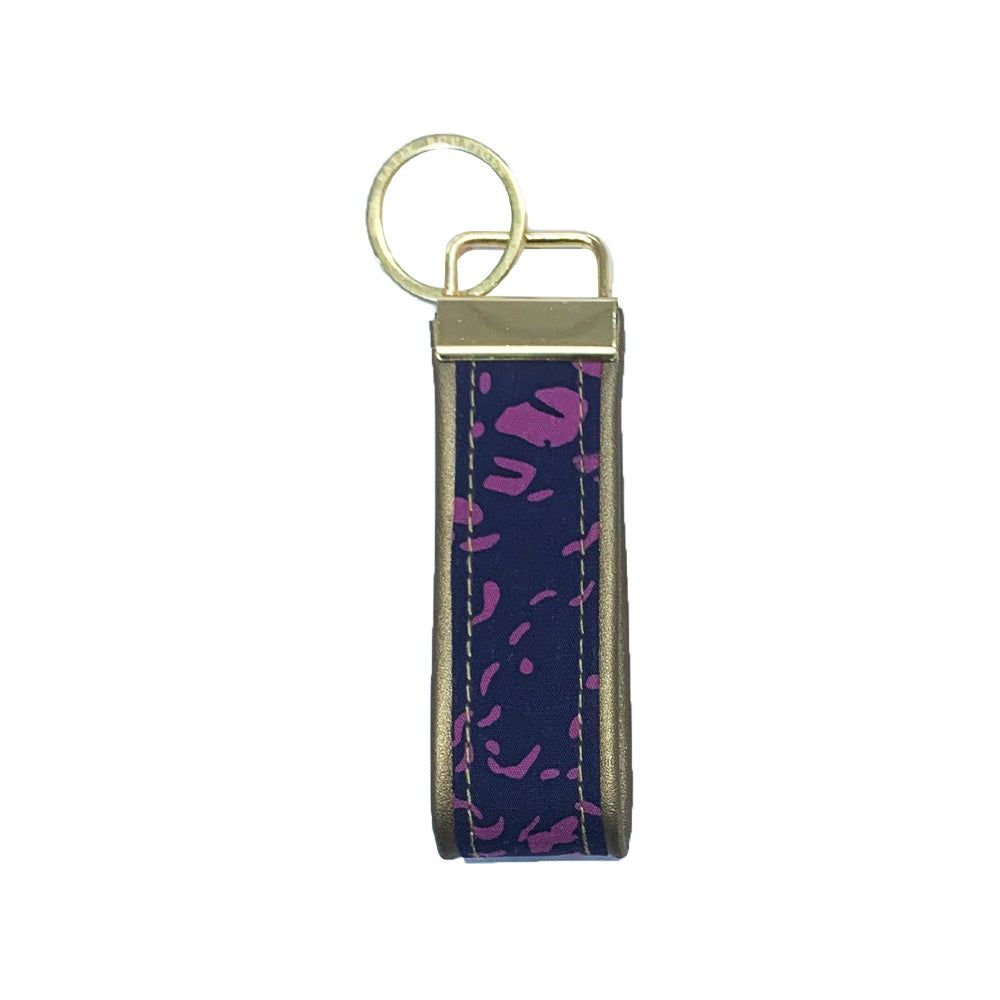 A whitebox photo of batik keyfob in purple bintik showing frontside of the keyfob