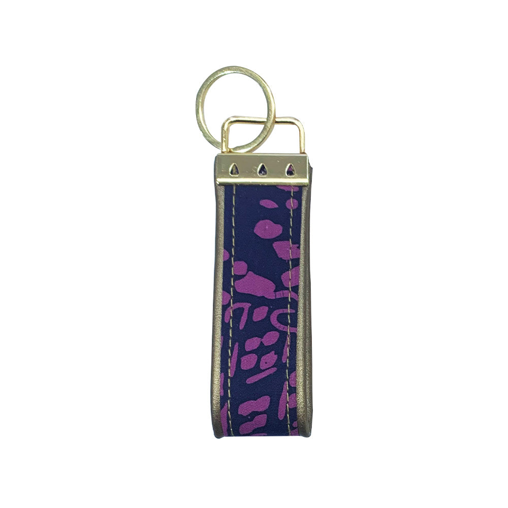 A whitebox photo of batik keyfob in purple bintik showing backside of the keyfob