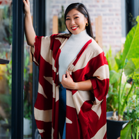 a woman in a lifestyle photo wearing an authentic batik kimono in the pattern crimson rose