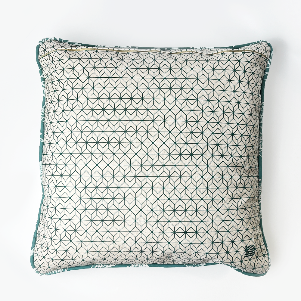 a reversible batik pillow against a neutral background