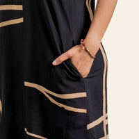 a closeup showcasing the details of the batik dress in the pattern black ecru