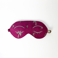 an eye mask in a white box photo made of batik in the pattern fuchsia palm