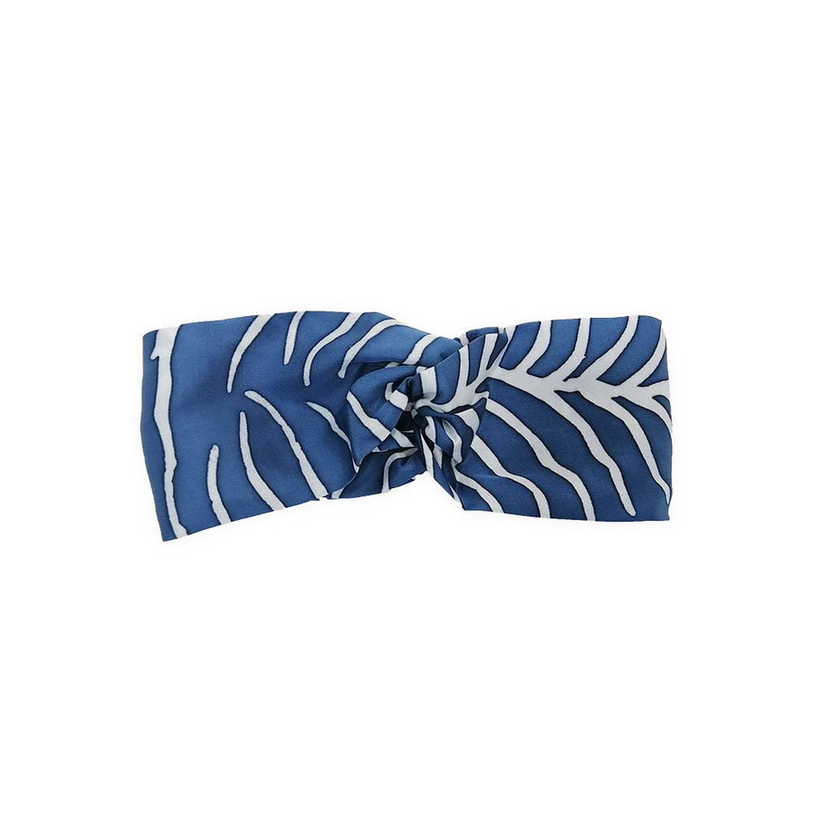 a headband being displayed in a white box to showcase the authentic batik in the pattern cobalt fern