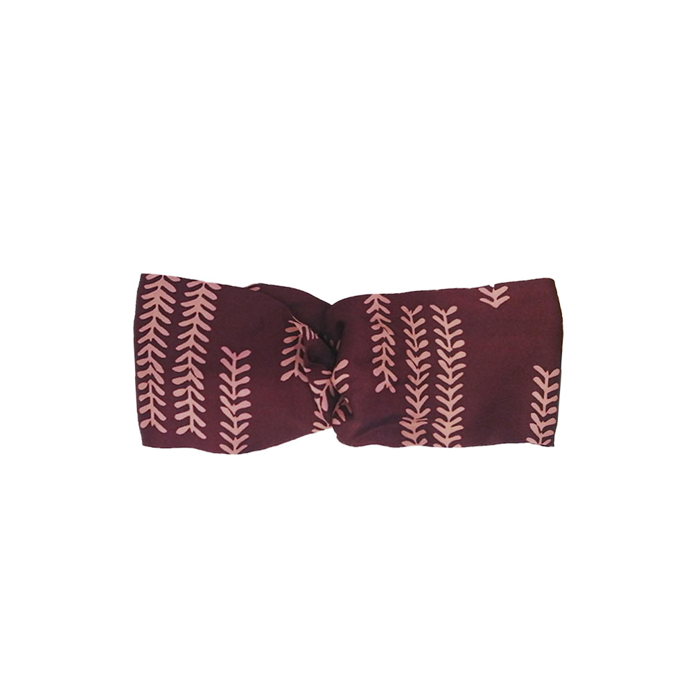 a front view of batik headband in a white box style photo