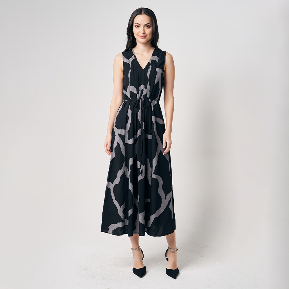 A whitebox photo of women standing in front of white background wearing flowy maxi dress in jet chain