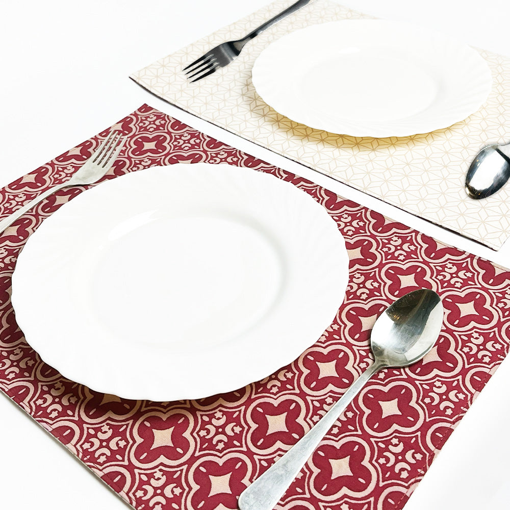 A lifestyle photo showcasing a dining table setting adorned with two crimson celestial batik placemats, adding a touch of elegance to the dining experience