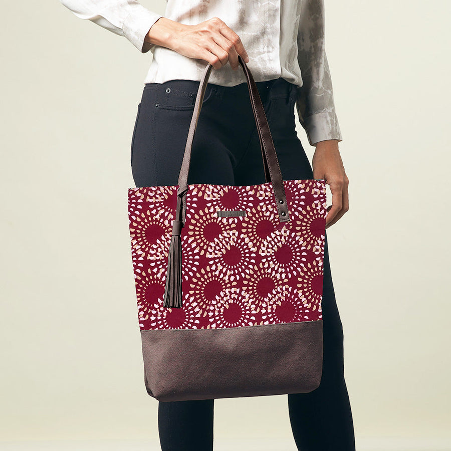 A women is holding Batik Tote Bag with canvas bag. In Crimson Lunar pattern 