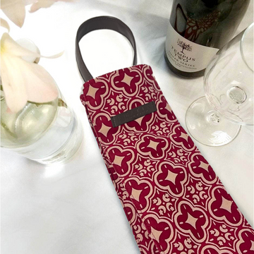 A visually appealing image featuring a batik wine bag adorned with wine, a wine glass, and complemented by vibrant flowers as charming props