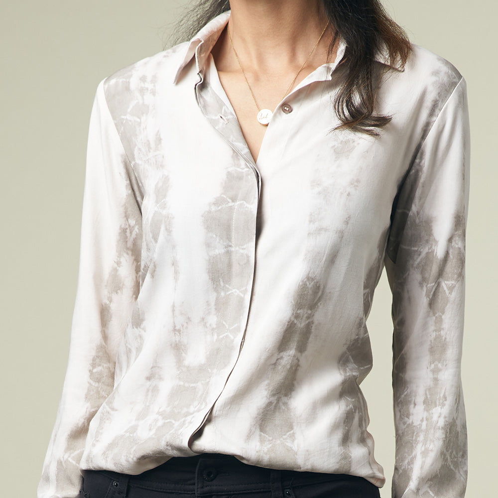 A model is posing in shibori long sleeved shirt in mangosteen pattern