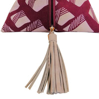 a close up photo of a bag made of batik shaped like a ketupat in the pattern crimson nasi lemak