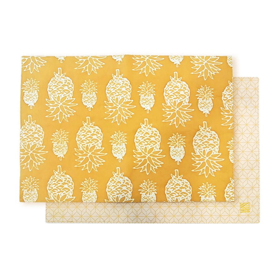 a whitebox photo of golden pineapple placemat against a neutral background 