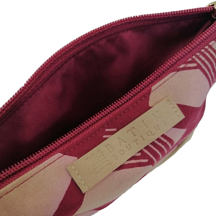 a closeup view of the batik zip pouch made of batik showcasing its details in the pattern crimson nasi lemak