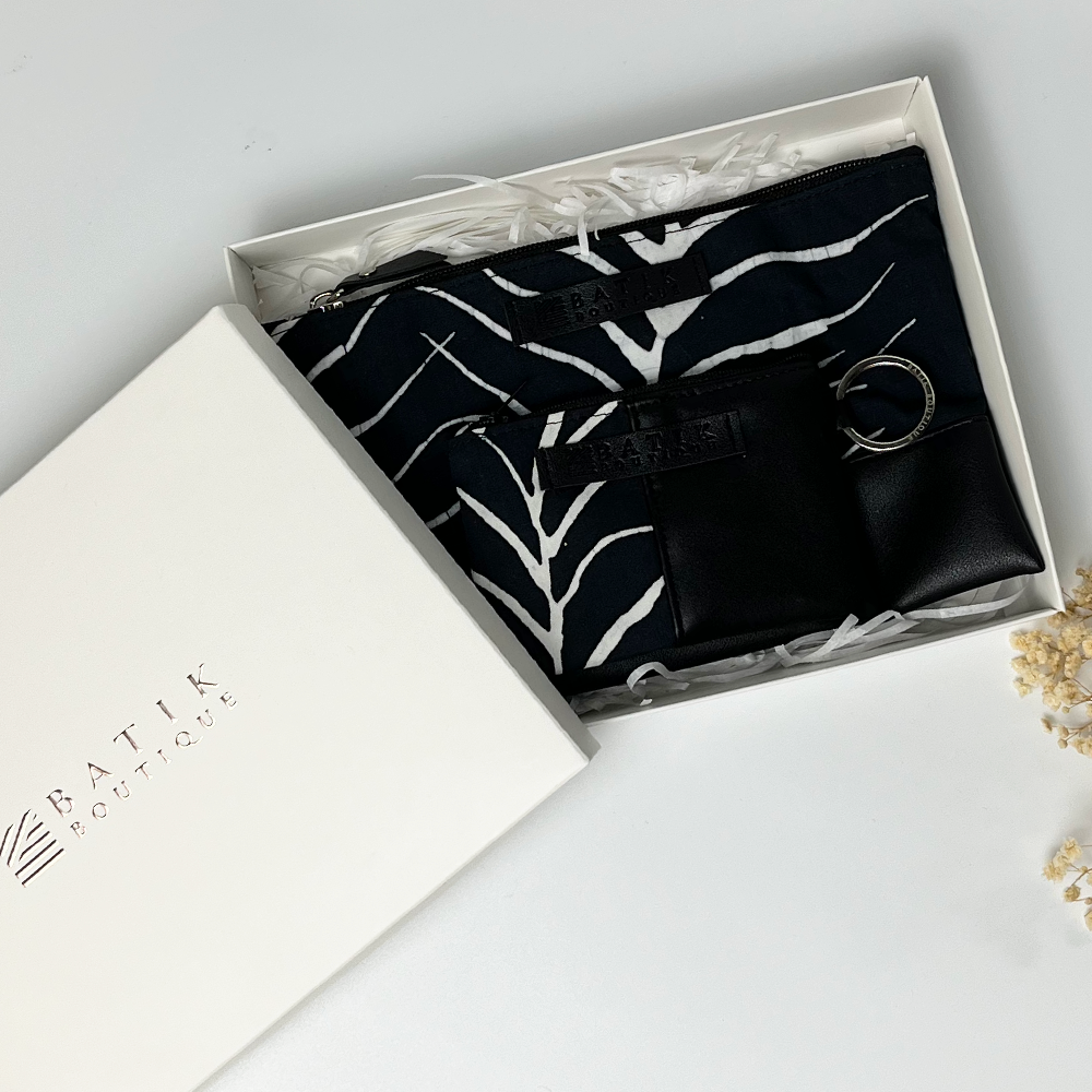 a picture of batik pouch and card holder wallet against a neutral background in a white box ready for gifting