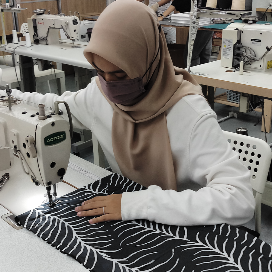a picture of a seamstress in the middle of sewing a batik fabric