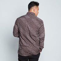 a back view of a man wearing a long-sleeved batik shirt in Brown Alur