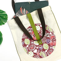 a lifestyle photo of batik inspired totebag in durian pattern in maroon color