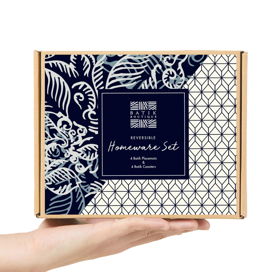 a picture of a reversible homeware set made of batik in the pattern blue nautical fern on a hand and against a neutral background