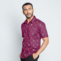 a man wearing batik shirt in Fuchsia Palm standing in front of white background 