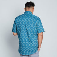 a man facing white background styling batik long sleeved in navy alur pattern  