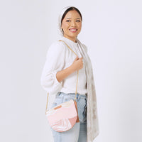  a woman standing in front of white background styling batik Moon Clutch Bag in Dawn Bukit pattern