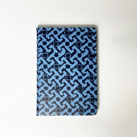 A photo showing batik-inspired leather notebook in midnight arabesque print