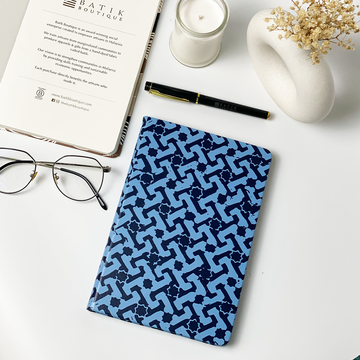 A lifestyle photo of batik inspired notebook in midnight arabesque pattern.