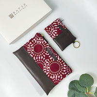 a flatlay photo of batik zip pouch and card holder wallet in crimson lunar pattern