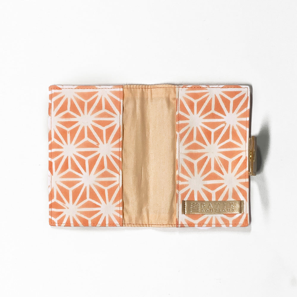 a photo of passport cover made of batik in the pattern peach firework