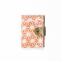 a front view photo of a passport cover in the pattern peach firework made of batik