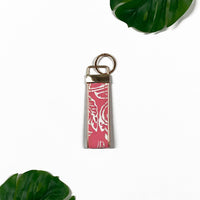 a lifestyle image of a key fob made of batik in the pattern pink floret