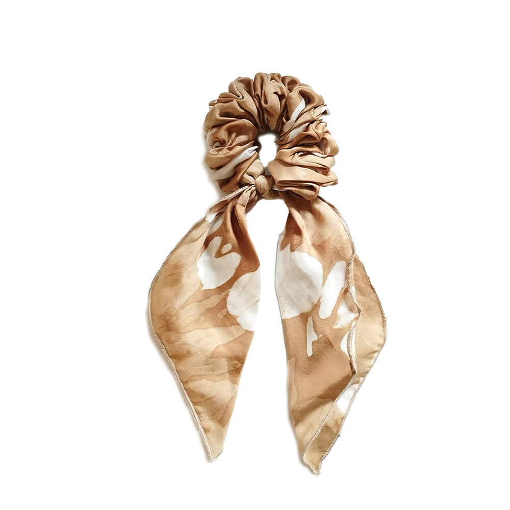A whitebox photo of scrunchies made from batik remnant in Ultra Golden print