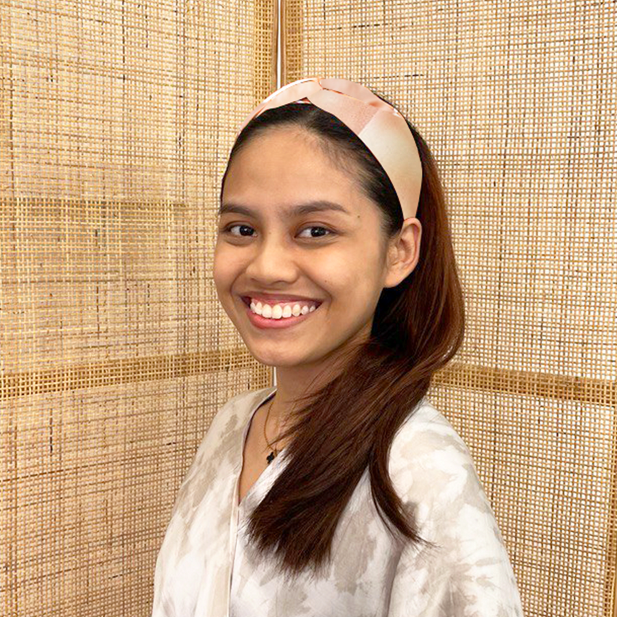 A model is wearing shibori headband in terracotta color. Made from shibori remnant fabric