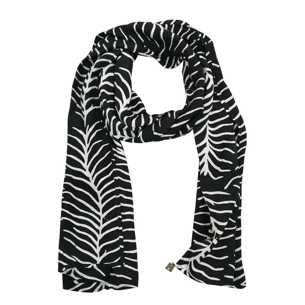 a whitebox photo of a batik scarf in the pattern black fern in front of a white background