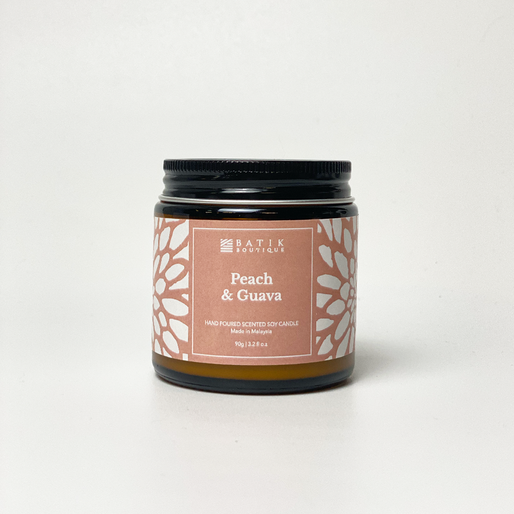 a white box style photo of a candle in the scent peach and guava against a neutral background