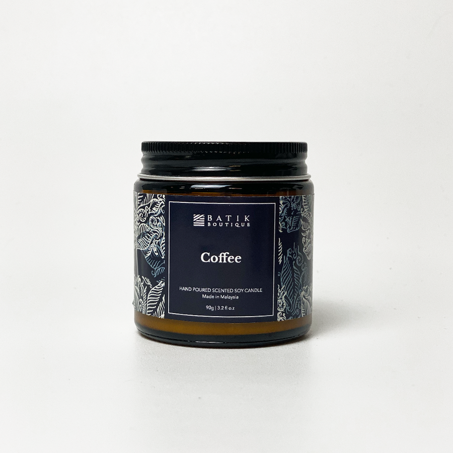 soy candle presented against a neutral background with batik inspired stickers