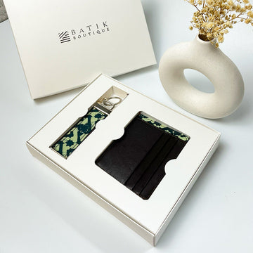 A lifestyle photo of batik travel set consist of sustainable batik card case and batik key fob in Forest Arabesque. Each products is made sustainably from batik remnant fabric