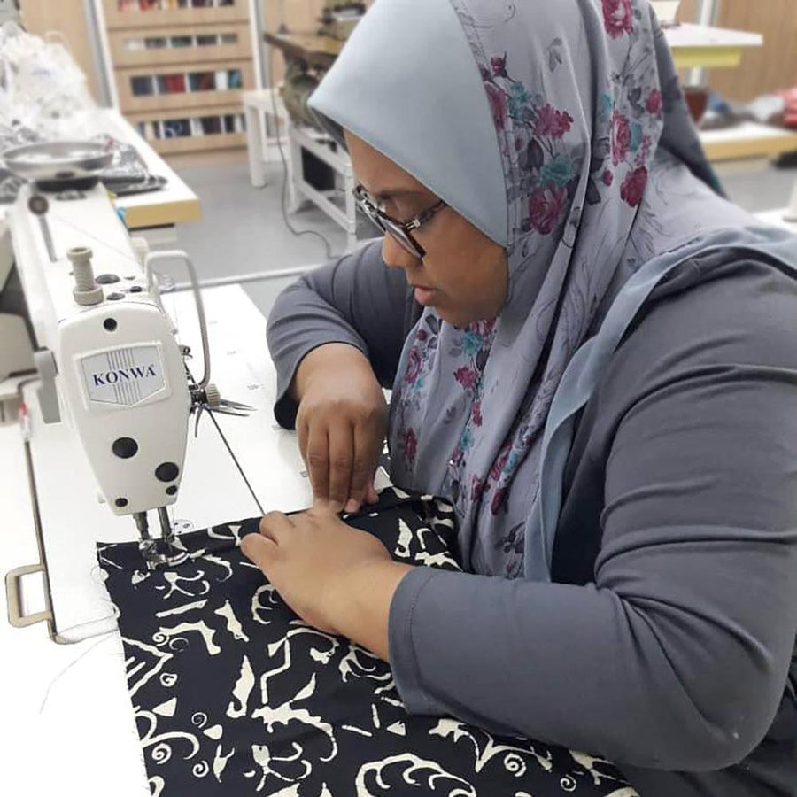  a photo showing a seamstress is sewing batik remnant