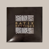A front photo of scarf packaging by Batik Boutique